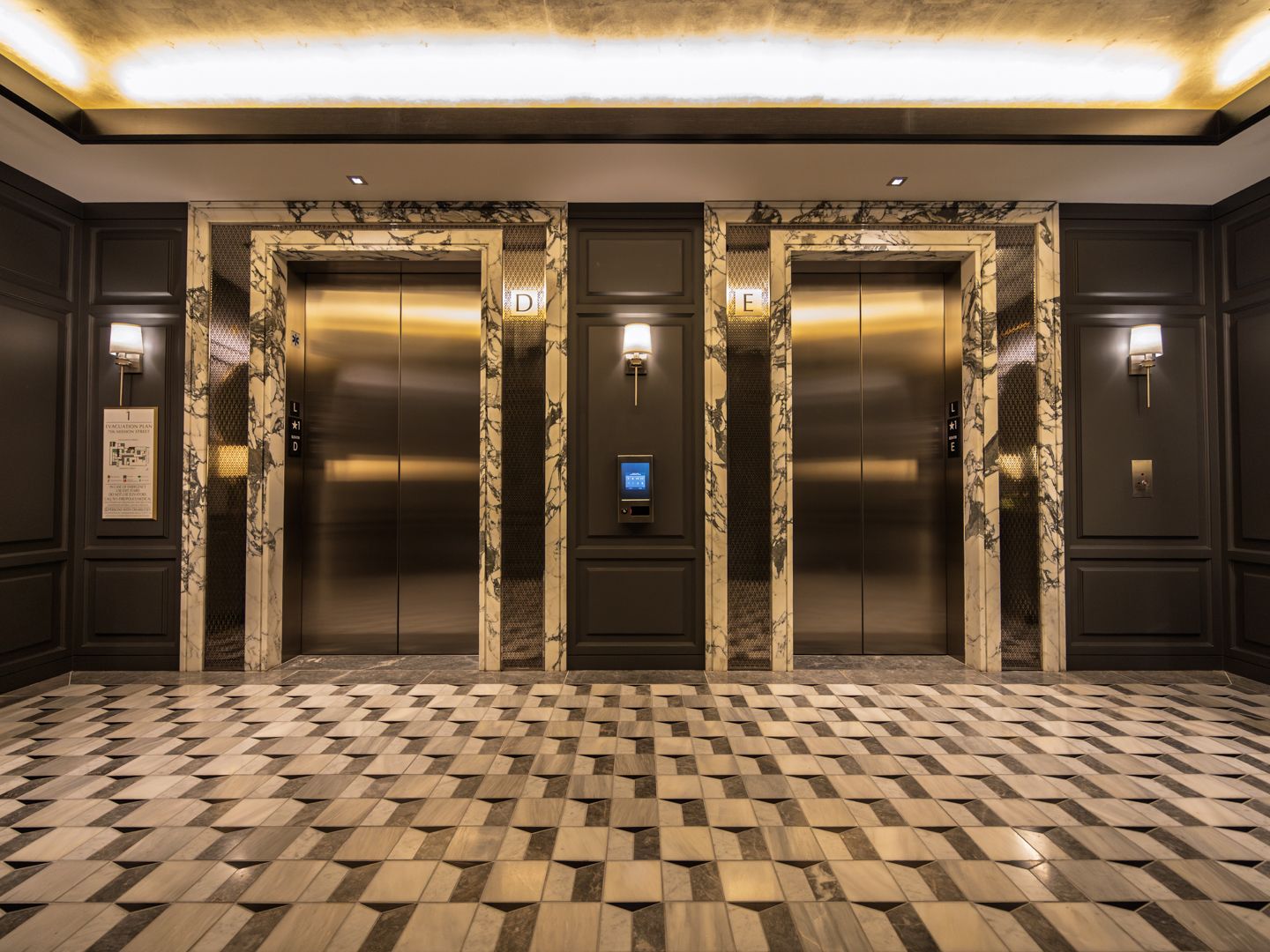 Residential elevator lobby with paneled walls at 706 Mission